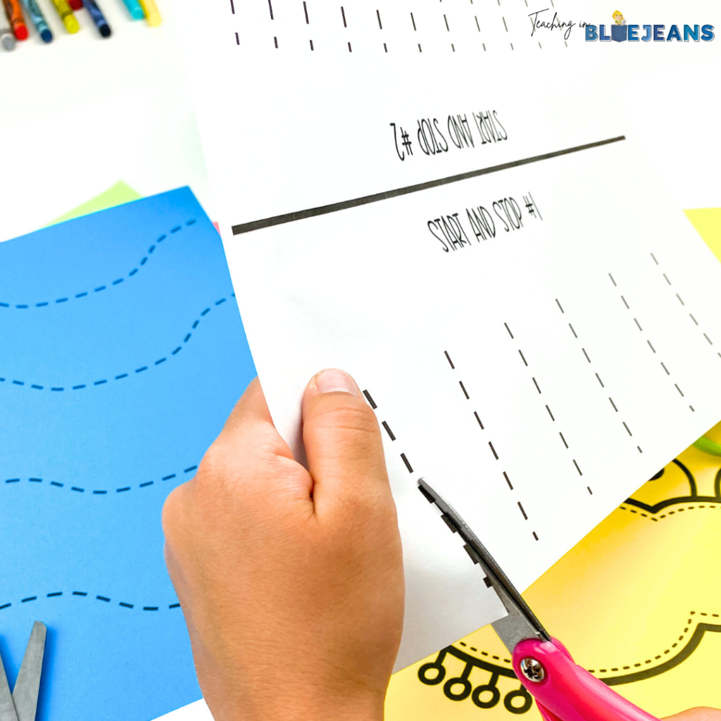 This is an image of a child using scissors to cut dotted lines in a scissor skills fine motor activity.