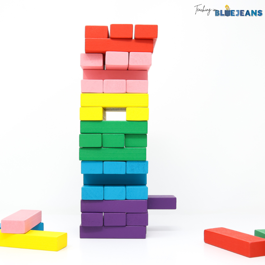 This image shows a rainbow wooden block game similar to Jenga. Blocks in different colors are stacked on top of each other.