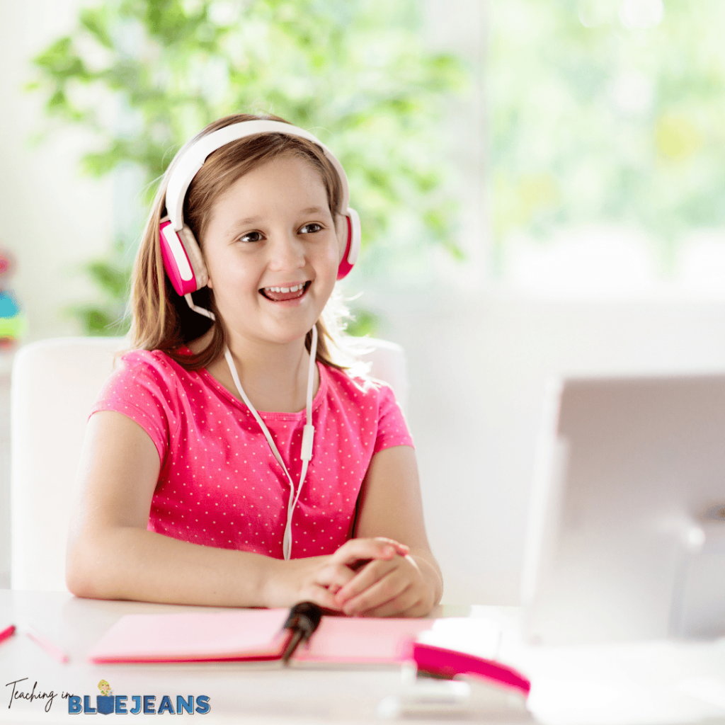 This image shows a student working on a computer and smiling.