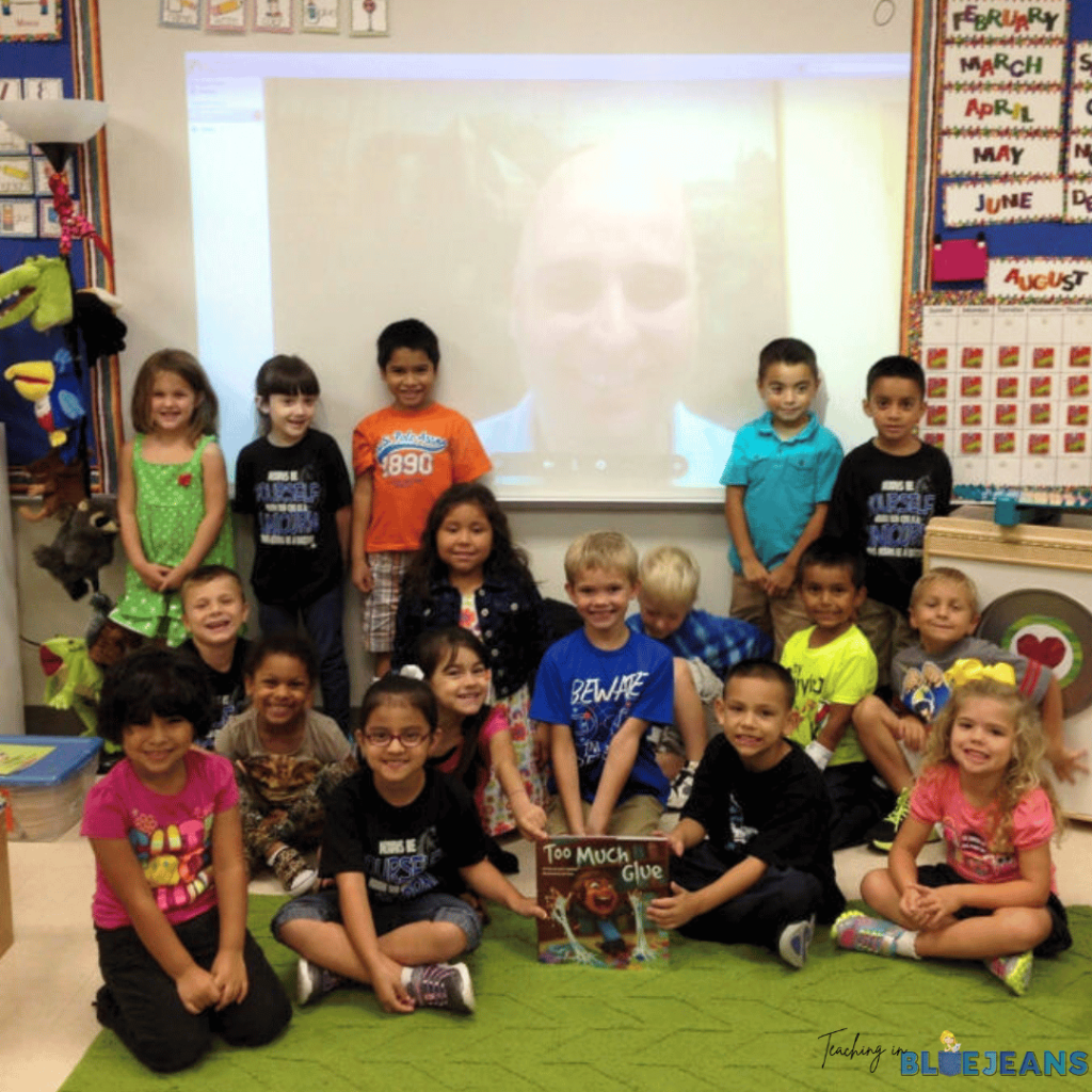 This photo shows a classroom of students posing with a guest speaker on the smart board as part of their experiential learning!